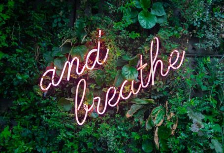 Retreat Calm - and breathe neon sign on tre