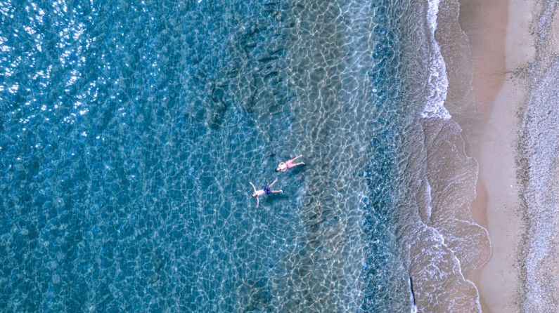 Calm Waves - a group of people swimming in the ocean