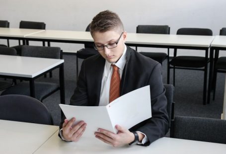 Resume Spotlight - man holding folder in empty room