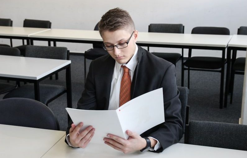 Resume Spotlight - man holding folder in empty room