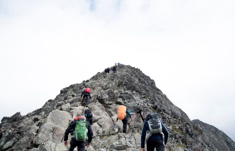 Leadership Development - climbers hiking through mountain peak during daytime