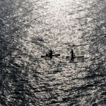 Fitness Harmony - two people in a canoe in the middle of the ocean